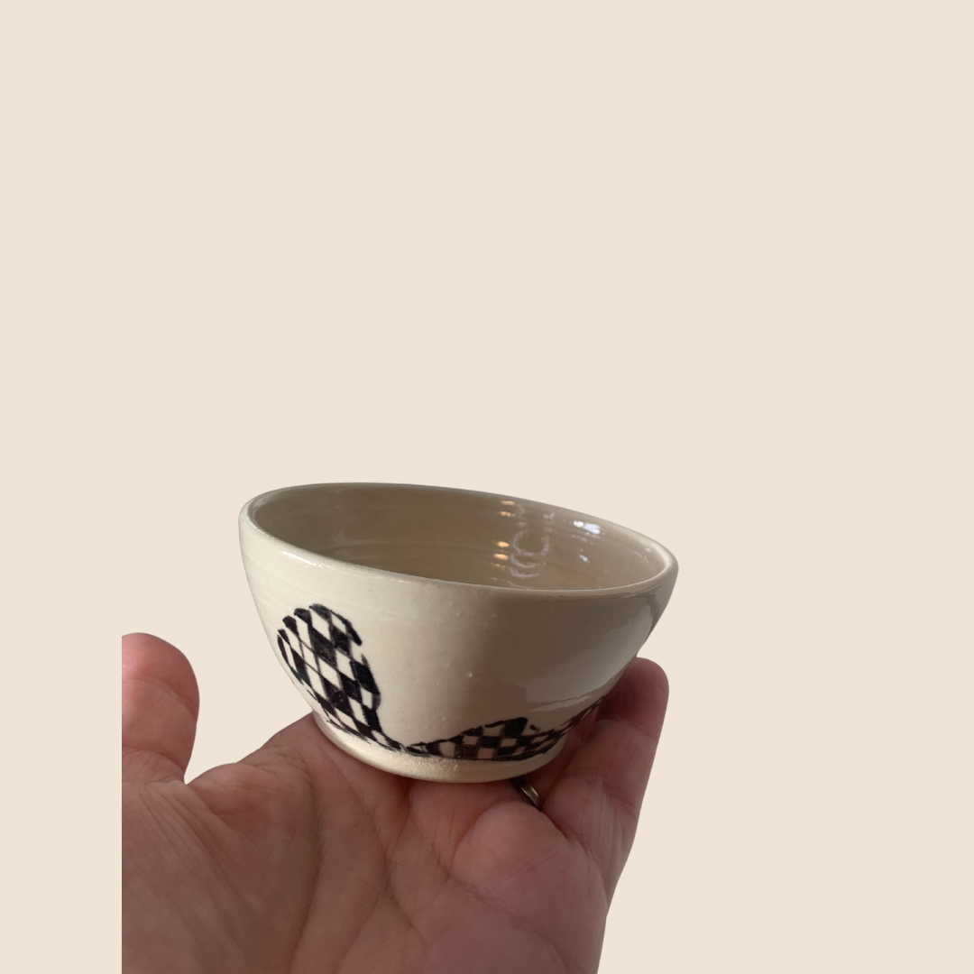 White trinket bowl with black squares and curves