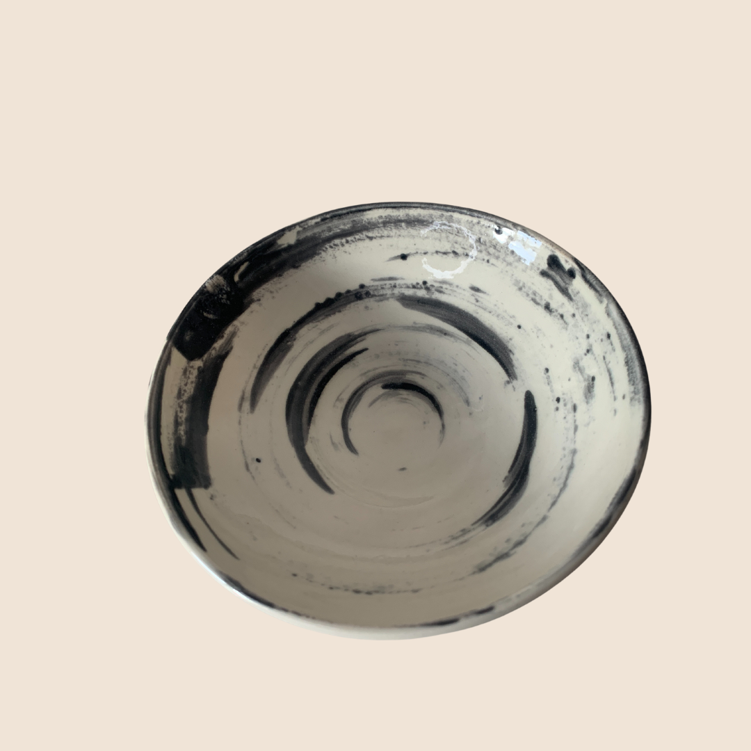 White bowl with black swirly glaze