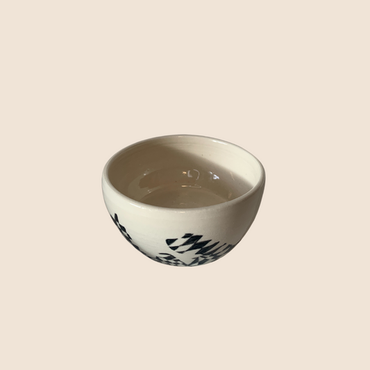 White trinket bowl with black diamonds and curves