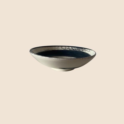 White bowl with rough texture black glaze