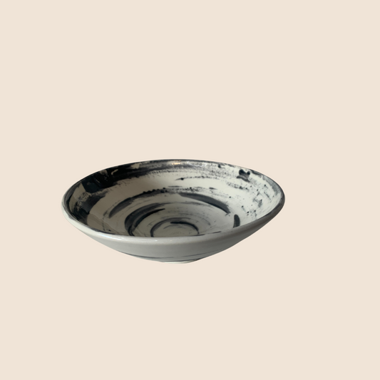 White bowl with black swirly glaze